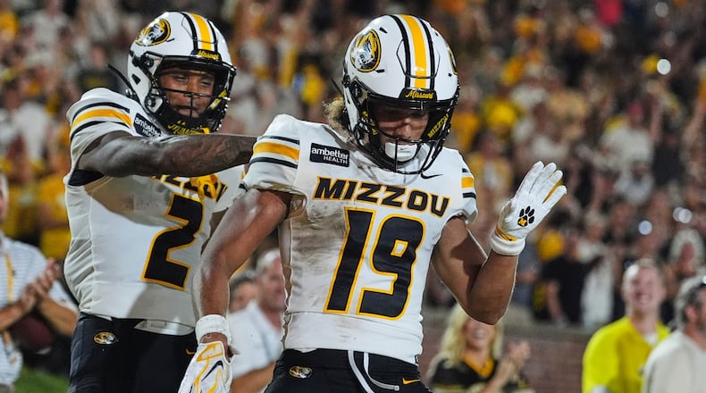 Missouri wide receiver Cayden Lee, right, is congratulated by Caleb Goodie Sr. (2) after scoring during the first half of an NCAA college football game against Arkansas-Pine Bluff Thursday, Sept. 3, 2026, in Columbia, Mo. (AP Photo/Jeff Roberson)