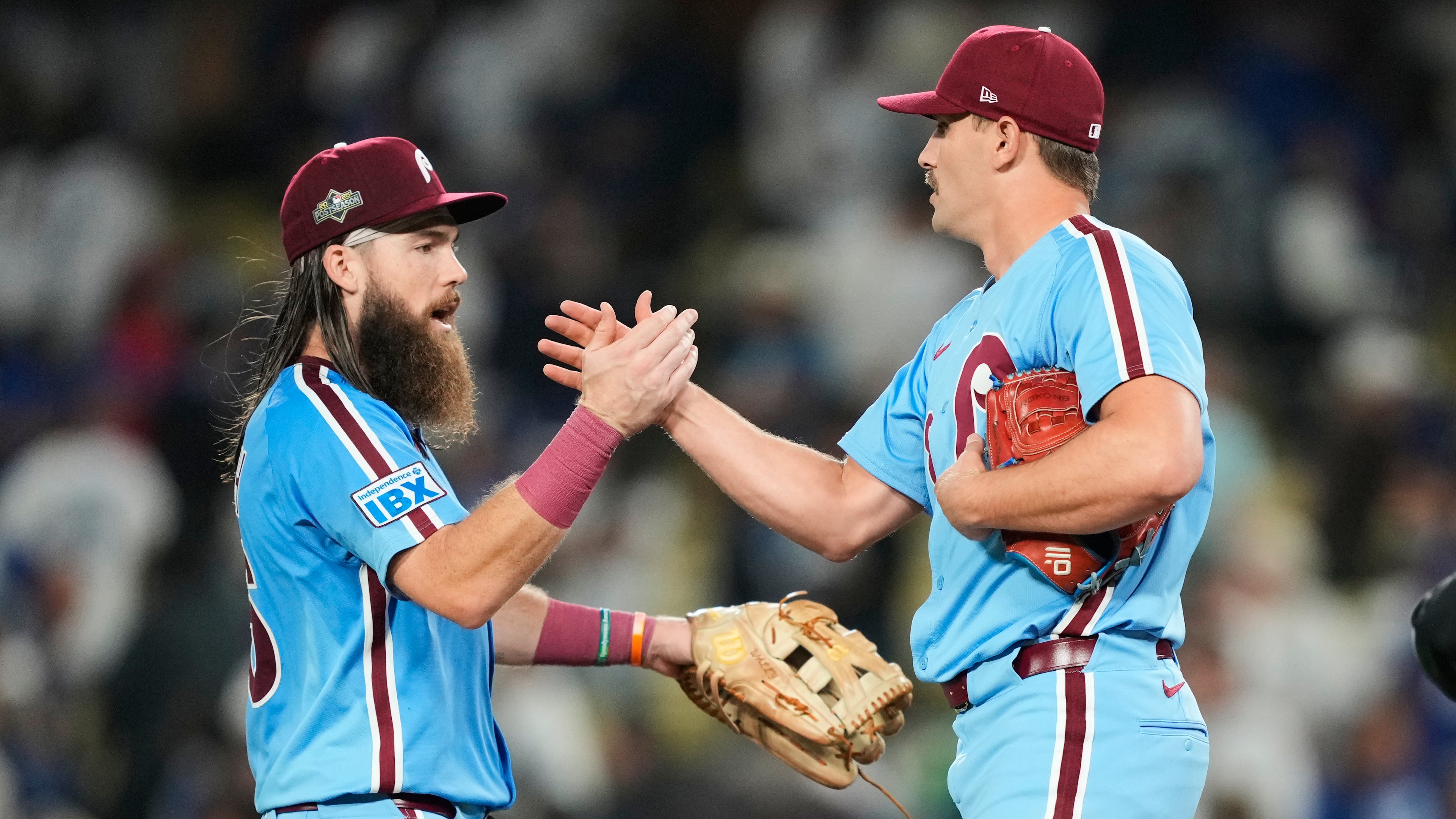 Philadelphia Phillies pitcher Tanner Banks shakes hands with center fielder Brandon Marsh after a win over the Los Angeles Dodgers in Game 3 of baseball's National League Division Series Wednesday, Oct. 8, 2025, in Los Angeles. (AP Photo/Mark J. Terrill)