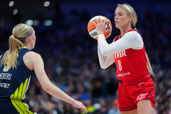Indiana Fever guard Sophie Cunningham, right, works the floor against Dallas Wings guard Paige Bueckers during the first half of a WNBA basketball game Friday, June 27, 2025, in Dallas. (AP Photo/Julio Cortez)