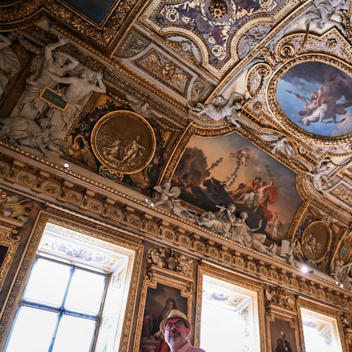 A visitor looks on during the reopening to the public of the Apollo Gallery, at the Louvre museum in Paris, Wednesday, July 22, 2026. (Lou Benoist/Pool Photo via AP)