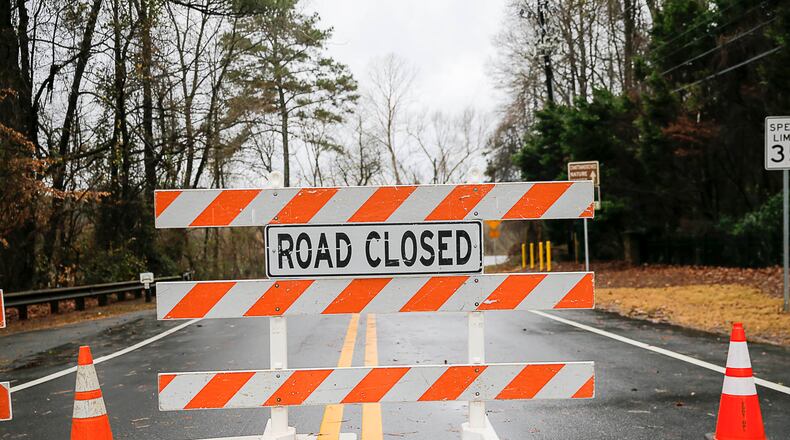 A road closure sign deters drivers from traveling along flooded Azalea Road in Roswell, Friday, December 28, 2018, in this AJC file photo. South Cobb Drive in Marietta will close for two months while the Georgia Department of Transportation replaces a large, failing drainage pipe, starting Tuesday, March 19, 2024. (ALYSSA POINTER/ALYSSA.POINTER@AJC.COM)