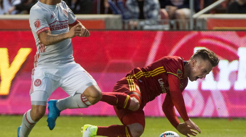 Real Salt Lake midfielder Albert Rusnak, right, gets knocked to the ground by Atlanta United forward Hector Villalba in an MLS soccer match in Salt Lake City on Wednesday, April 22, 2017. (Rick Egan/The Salt Lake Tribune via AP)