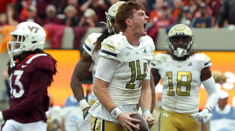 Georgia Tech quarterback Zach Pyron (14) celebrates a touchdown run in the second half of an NCAA college football game against Virginia Tech, Saturday, Nov. 5 2022, in Blacksburg, Va. (Matt Gentry/The Roanoke Times via AP)