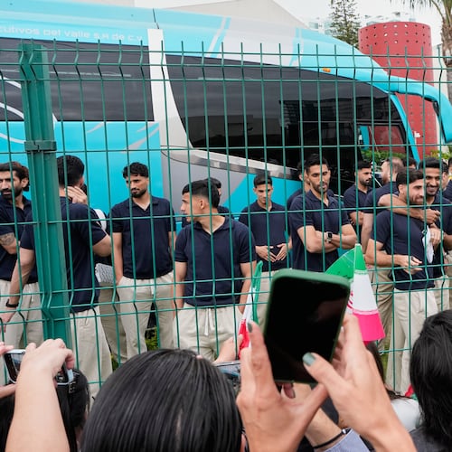 Fans greet members of the Iran World Cup soccer team as they leave their hotel for the airport Tuesday, June 30, 2026, in Tijuana, Mexico. (AP Photo/Gregory Bull)