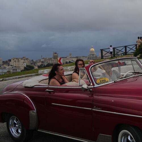 Tourists take a ride in a classic American car in Havana, Monday, Jan. 26, 2026. (AP Photo/Ramon Espinosa)