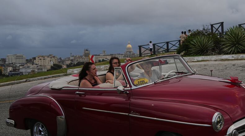 Tourists take a ride in a classic American car in Havana, Monday, Jan. 26, 2026. (AP Photo/Ramon Espinosa)