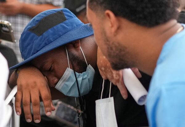Family members wait at the morgue for the bodies of their loved one who died at the roof collapse of the Jet Set nightclub, where more than 200 people died, outside at the National Institute of Forensic Pathology in Santo Domingo, Dominican Republic, Friday, April 11, 2025. (AP Photo/Matias Delacroix)