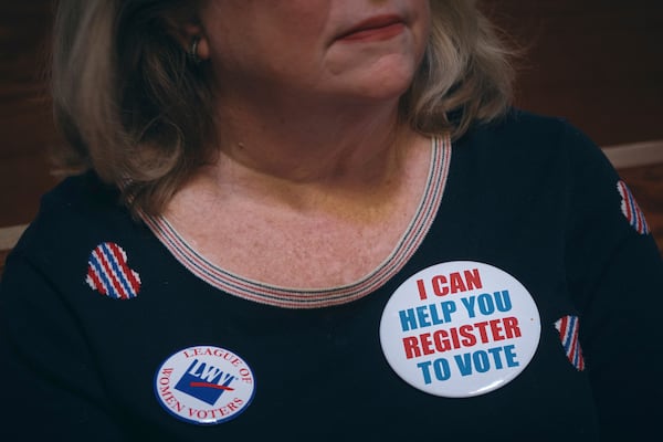 Voting activist Danna Ward listens to a speaker during a Town Hall and voter registration for school board elections at the Bethany Baptist Church, Saturday, Feb. 1, 2025, in Newark, N.J. (AP Photo/Andres Kudacki)
