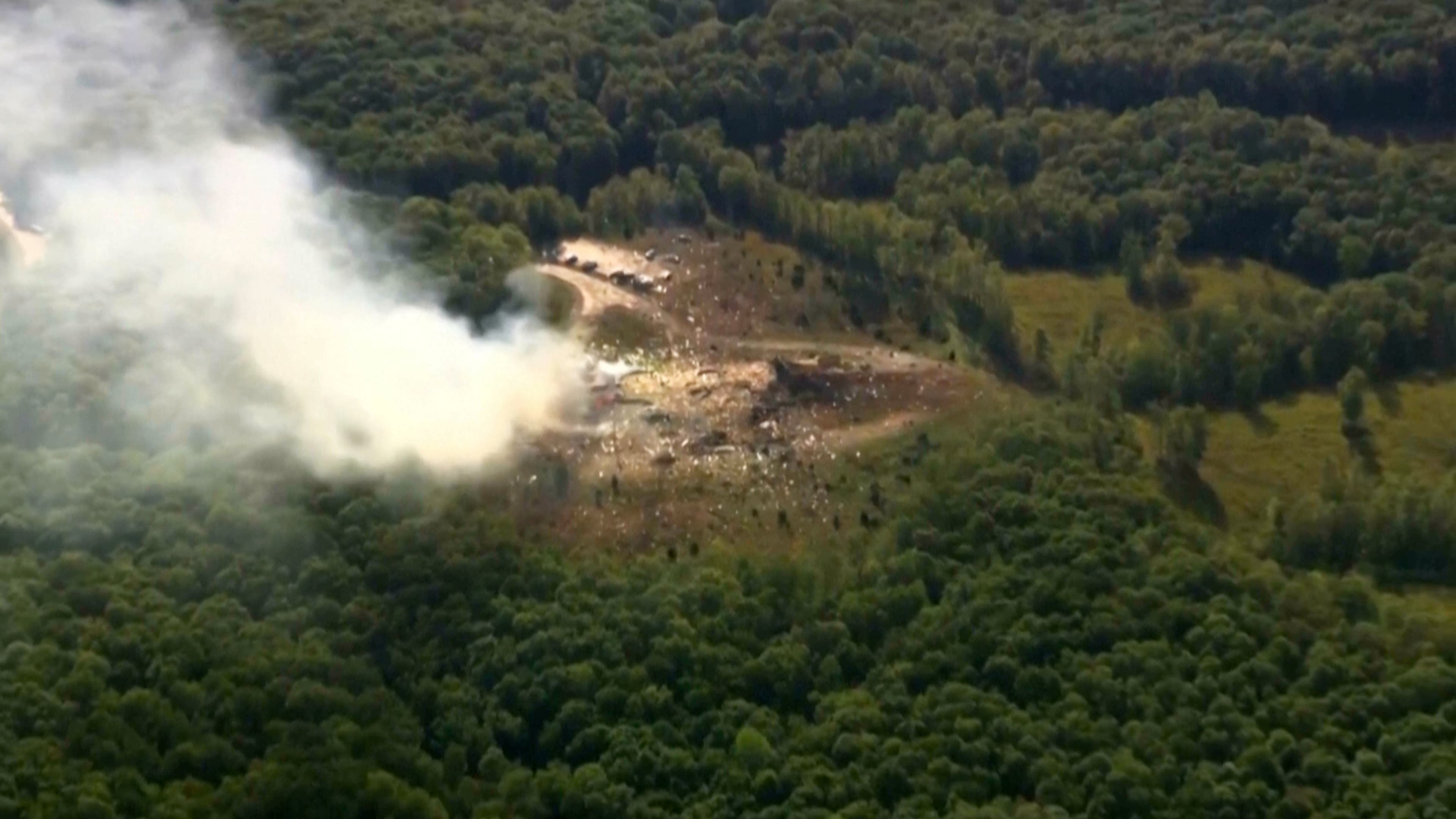 Smoke fills the air as debris covers the ground and vehicles after a powerful blast ripped through a military explosives manufacturing plant in Hickman County, Tenn., on Friday, Oct. 10, 2025. (WTVF-TV via AP)