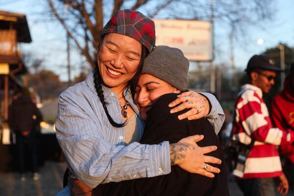 DJ Mikkoh hugs a friend before her set at Portrait Coffee in Atlanta on Thursday, March 19, 2026. (Abbey Cutrer/AJC)