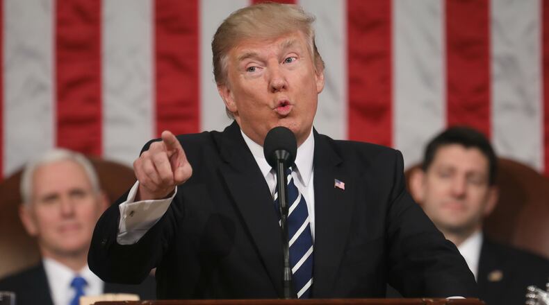 U.S. President Donald J. Trump (C) delivers his first address to a joint session of the U.S. Congress as U.S. Vice President Mike Pence (L) and Speaker of the House Paul Ryan (R) listen on February 28, 2017.