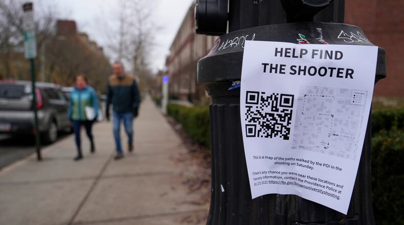 A poster seeking information about the campus shooting suspect is seen on the campus of Brown University, Wednesday, Dec. 17, 2025, in Providence, R.I. (AP Photo/Robert F. Bukaty)
