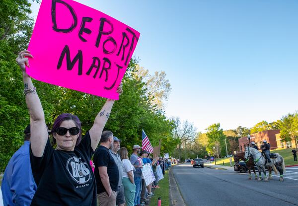 Protesters lined the street outside the Acworth Community Center, where U.S. Rep. Marjorie Taylor Greene, R-Rome, held a town hall on Tuesday, April 15, 2025. (Jenni Girtman for The Atlanta Journal-Constitution)