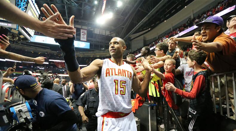 Hawks’ Al Horford high fives fans leaving the court with a 89-72 victory over the Celtics in Game 2 of their Eastern Conference playoffs at Philips Arena on Tuesday, April 19, 2016. Curtis Compton / ccompton@ajc.com