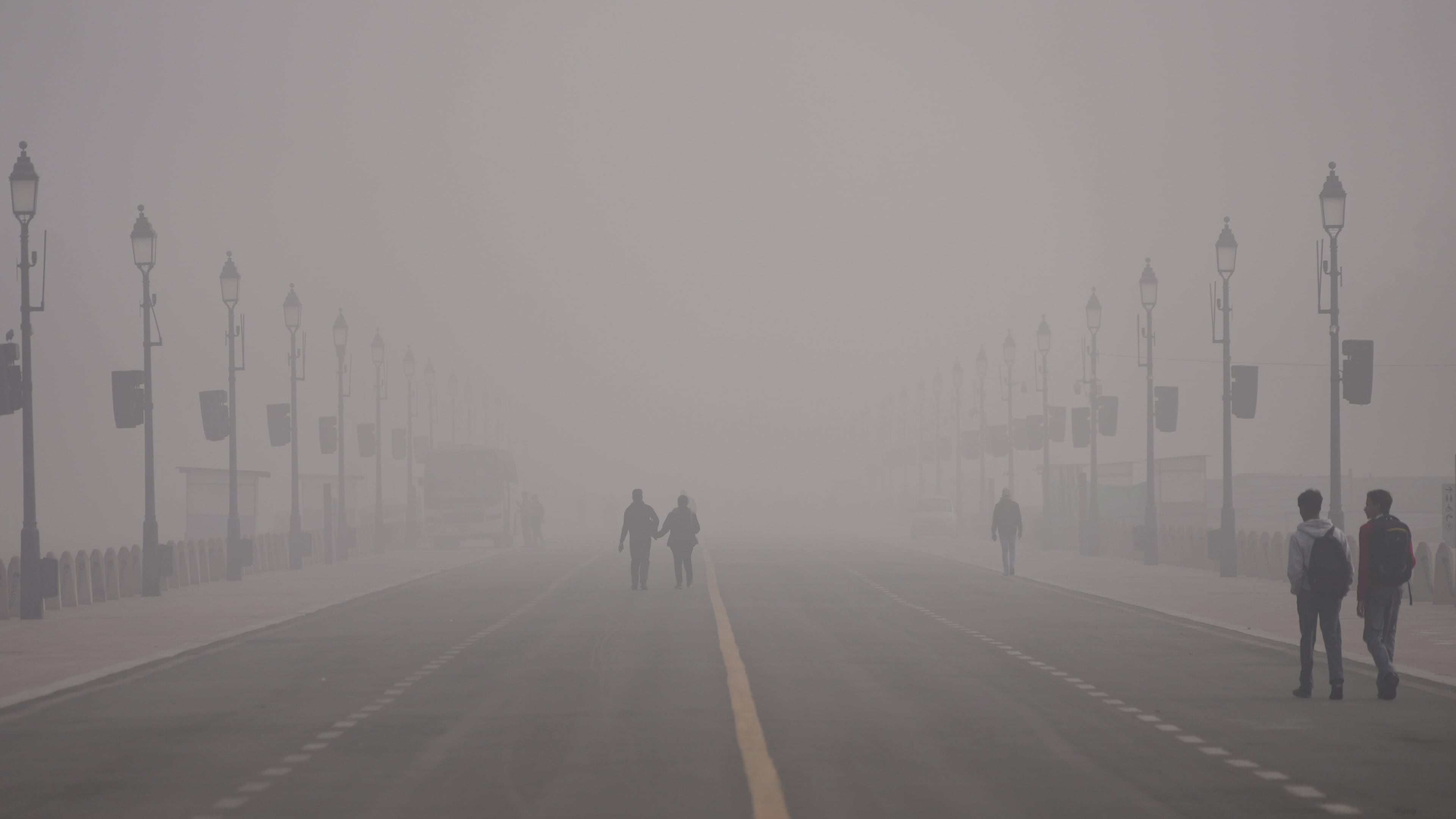 People walk in a smog-covered morning in New Delhi, India, Monday, Dec. 15, 2025. (AP Photo/Piyush Nagpal)