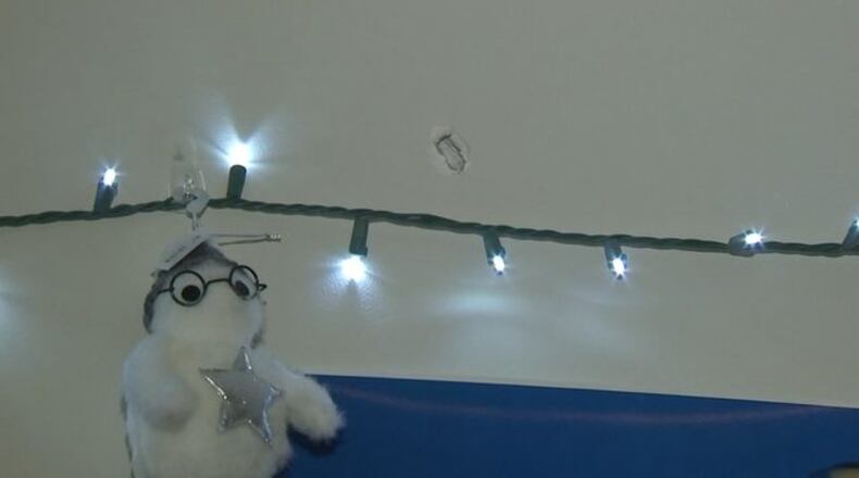 A photo from the scene shows where the bullet hit in a bedroom inside the Ellenwood home.