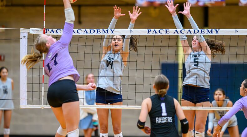 Olivia Siskin (center) and Jolie Litvak defend a play at the net for the Pace Academy volleyball team earlier this year. Pace Academy is set to face Marist on Thursday, Oct. 30, during the state championship matches. (Courtesy of Pace Academy)