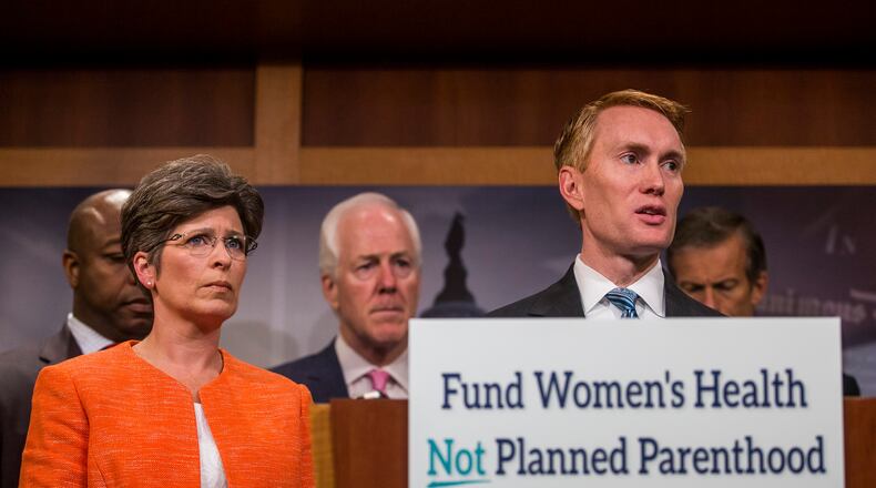 Sen. Joni Ernst, R-Iowa, and Sen. James Lankford, R-Okla., during a news conference about defunding Planned Parenthood on Capitol Hill, July 29. (Zach Gibson / The New York Times)