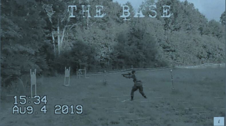 An unknown person fires at paper targets in a propaganda video from The Base. Federal investigators say the video was taken at Luke Lane’s compound outside of Rome, Ga.