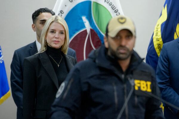 Attorney General Pam Bondi, left, listens as FBI Director Kash Patel speaks about a 24 year-old MS-13 gang leader who was arrested in an operation by the Virginia Homeland Security Task Force in Dale City, VA., on March 27, 2025, during a news conference at the Manassas FBI Field Office, Thursday, March 27, 2025, in Manassas, VA. (AP Photo/Rod Lamkey)