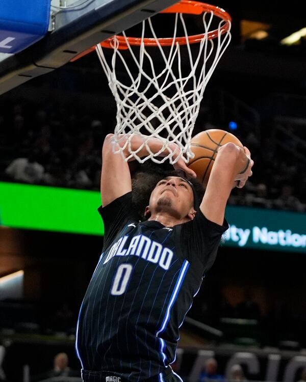 Orlando Magic guard Anthony Black (0) dunks the ball against the Atlanta Hawks during the second half of an NBA basketball game, Tuesday, April 8, 2025, in Orlando, Fla. (AP Photo/John Raoux)