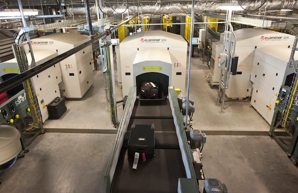 FILE - Air travelers' bags ride a conveyor into one of three new advanced in-line screening machines at Bill and Hillary Clinton National Airport in Little Rock, Ark., Oct. 16 2012. (AP Photo/Danny Johnston, File)
