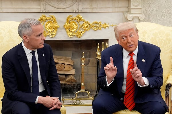 Prime Minister Mark Carney and U.S. President Donald Trump engage in a meeting at the White House in Washington, D.C., Tuesday, May 6, 2025. (Adrian Wyld /The Canadian Press via AP)