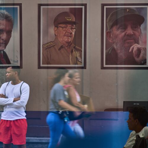 Images of Cuba's President Miguel Diaz-Canel, Raul Castro, and Fidel Castro, are seen at the state building in Havana, Cuba, Wednesday, May 20, 2026. (AP Photo/Ramon Espinosa)