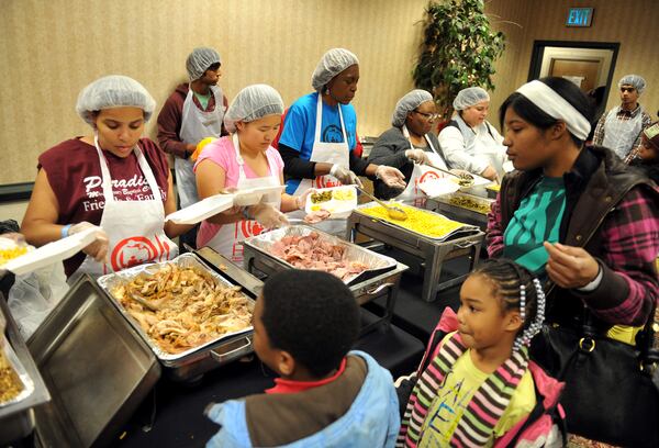 About 1,000 volunteers served food, handed out toys and entertained families during the Hosea Feed the Hungry and Homeless Annual Children's Christmas Party at the Atlanta Civic Center Friday December 20, 2013.