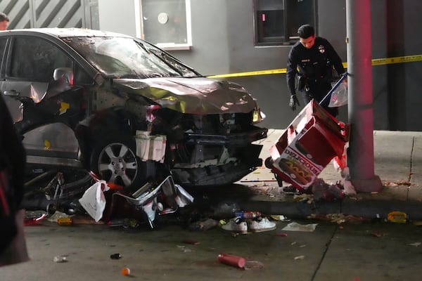 A vehicle sits on the sidewalk after ramming into a crowd of people waiting to enter a nightclub along a busy boulevard in Los Angeles early Saturday, July 19, 2025 injuring several people. (AP Photo/Damian Dovarganes)