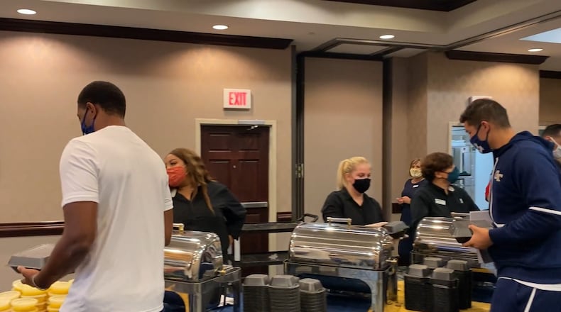 Georgia Tech players fill to-go cartons for their meal prior to their Sept. 12, 2020 game against Florida State in Tallahassee, Fla.