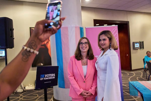 Bella Bautista, 22, right, a transgender woman, has a photo taken with Rep. Sarah McBride, D-Del., the first trans woman to be a member of Congress, during a reception held by the Christopher Project, a trans rights organization, after the Human Rights Conference during World Pride, Thursday, June 5, 2025, in Washington. (AP Photo/Jacquelyn Martin)