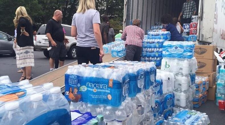 Volunteers prepare packages of bottled water to be delivered from Atlanta to Houston after Hurricane Harvey in 2017.