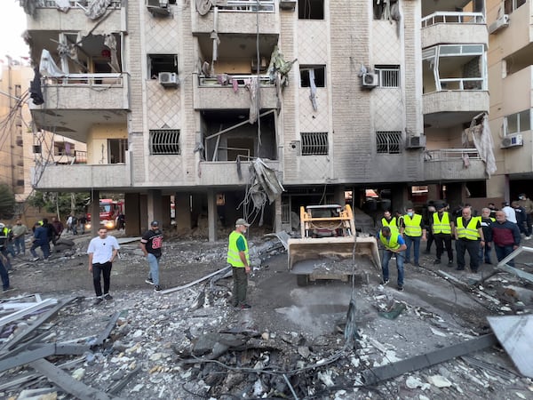 Rescue workers remove debris at the site of an Israeli airstrike in Dahiyeh, the southern suburb of Beirut, Lebanon, Sunday, April 27, 2025. (AP Photo/Hussein Malla)