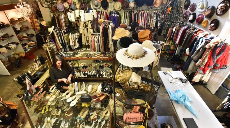 December 2, 2016 Atlanta - Christy Ogletree Ahlers, owner of Peachtree Battle Estate Sales and Liquidations, prepares for the estate sale of Diane McIver’s wardrobe next week as she is surrounded by more than 2,000 of Diane McIver’s clothing and jewelry items in a warehouse showroom at Peachtree Battle Estate Sales and Liquidations on Friday, December 2, 2016. More than 2000 of her articles of clothing, jewelry, hats and shoes are on display in his warehouse showroom. Tex McIver has enlisted an estate liquidation company to sell more than 2,000 of his deceased wife’s clothing and jewelry items. HYOSUB SHIN / HSHIN@AJC.COM