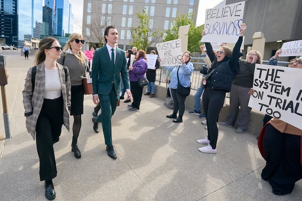 Alex Formenton, one of five hockey players charged with sexual assault, passes protestors as he arrives at the courthouse in London, Ontario, Thursday, May 8, 2025. (Geoff Robins/The Canadian Press via AP)