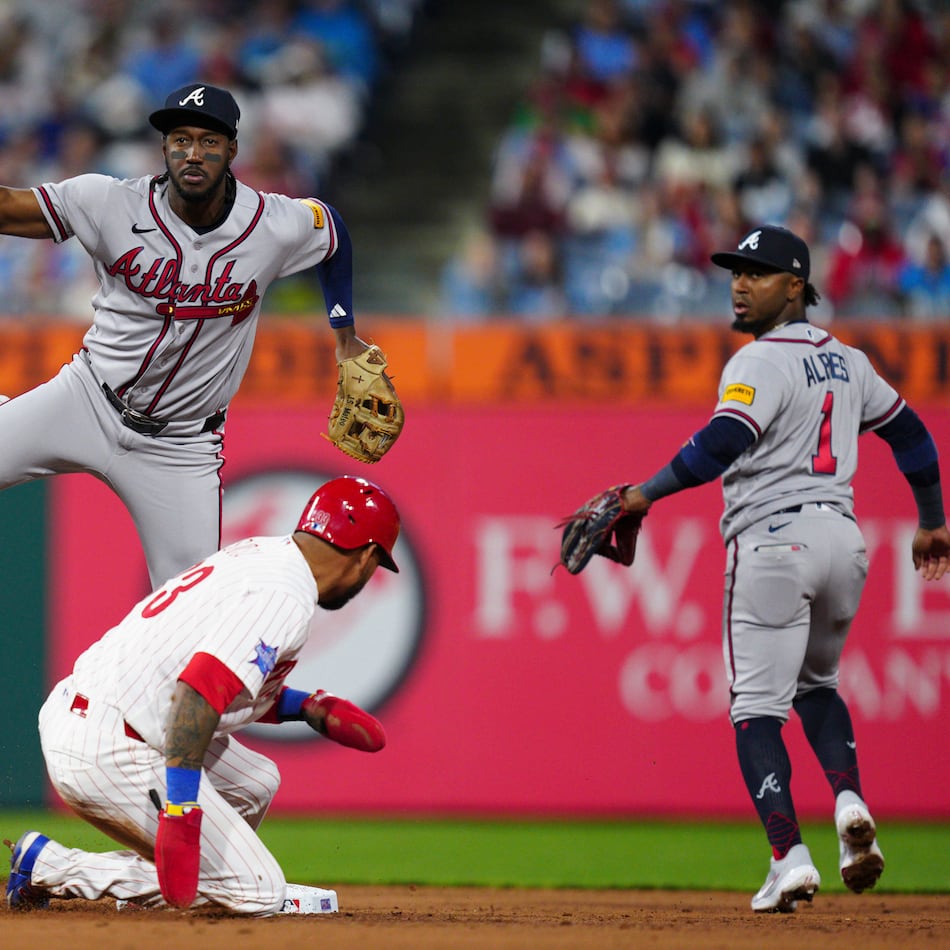 The Braves' Jorge Mateo (top center) throws to first base over Phillies' Edmundo Sosa to complete a double play during the fifth inning Saturday, April 18, 2026, in Philadelphia. Philadelphia's Brandon Marsh was out at first. (Derik Hamilton/AP)