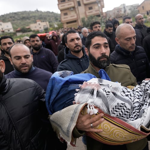 A Palestinian man carries Muhammad Bani Odeh, 5, at the funeral of four members of the Odeh family who were killed in their car by Israeli security forces during an army operation in Tammun, West Bank, Sunday, March 15, 2026. (AP Photo/Majdi Mohammed)