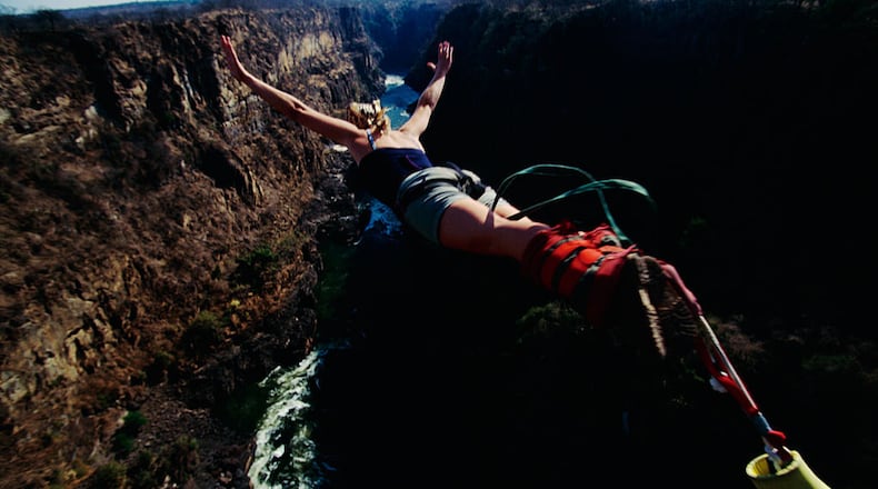 A woman takes a leap of faith as she bungee jumps into a freefall. A woman on a bungee-style ride at a Paris ride also ended up in a freefall, but it was because her seat belt failed.