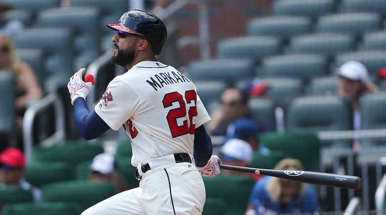 Atlanta Braves right fielder Nick Markakis (22) follows through on a two-run double int he second inning of a baseball game against the Cincinnati Reds, Sunday, Aug. 20, 2017, in Atlanta. (AP Photo/John Bazemore)