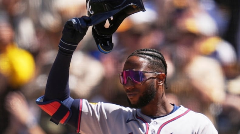 Atlanta Braves' Jurickson Profar acknowledges the crowd as he walks up to bat during the first inning of an opening-day baseball game against his former team, the San Diego Padres, Thursday, March 27, 2025, in San Diego. (AP Photo/Gregory Bull)
