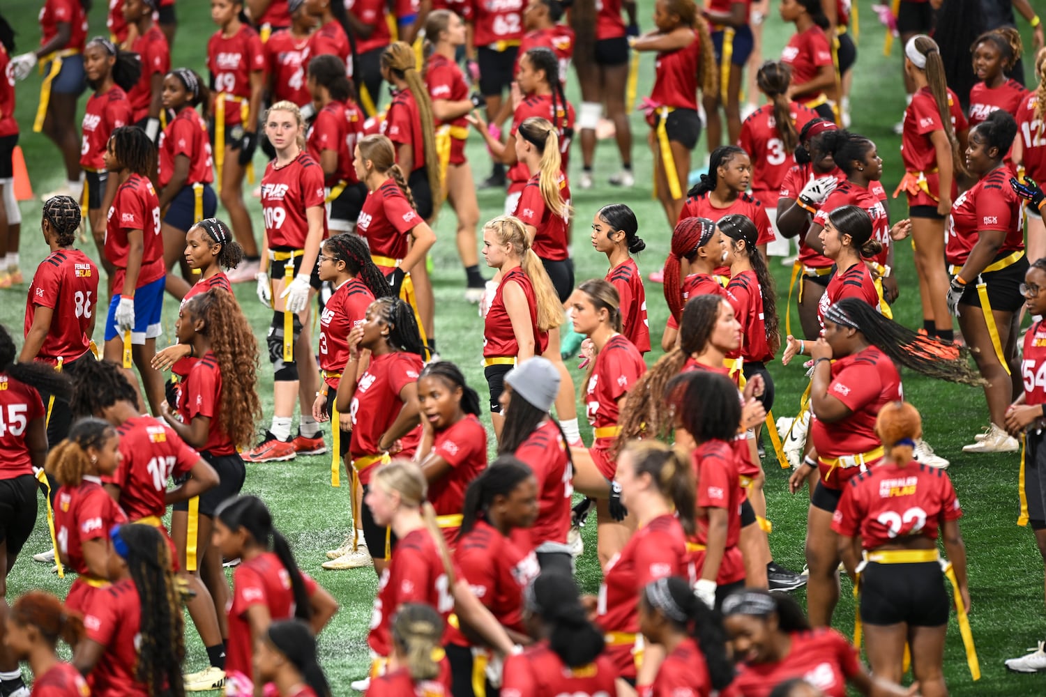 Girls run group drills during the 5th annual Girls Flag Football Showcase. (Daniel Varnado for the AJC)