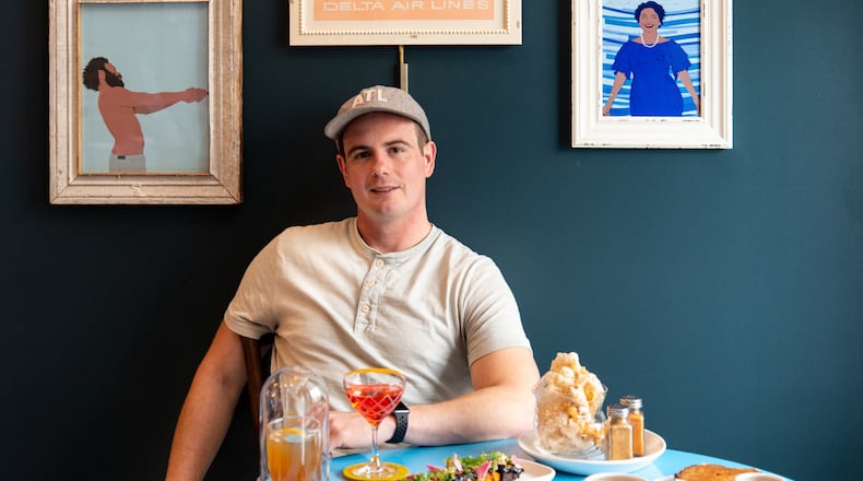 Joey Ward is executive chef of Southern Belle and Georgia Boy. Southern Belle is a tribute to the South served up with Atlanta-style wit, including a neon blue “Bless Your Heart” sign above the service bar. (Courtesy of Mia Yakel)