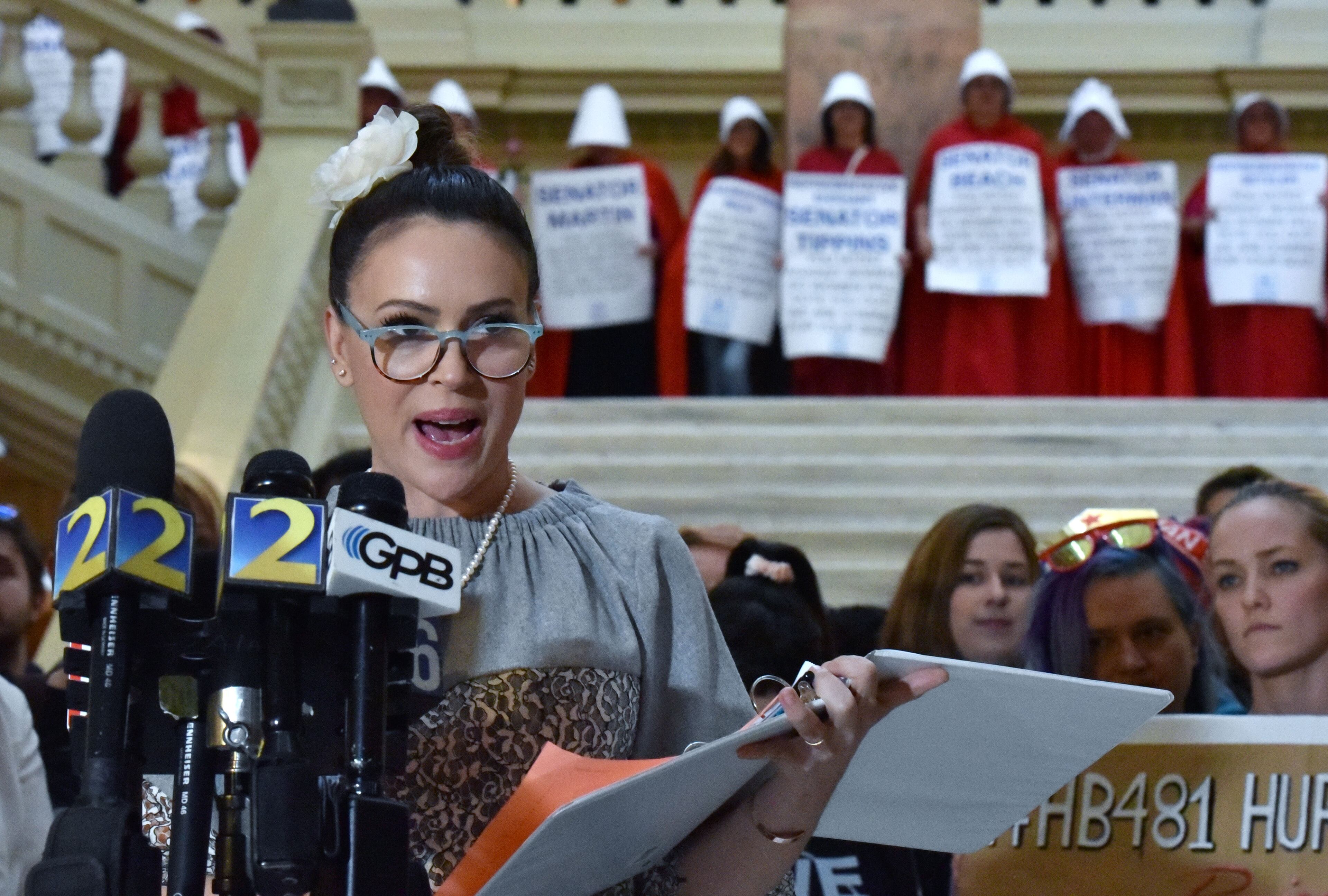 Actor Alyssa Milano reads her letter to Gov. Brian Kemp urging opposition to the “heartbeat” bill on the last day of the 2019 session of the Georgia Legislature. (Hyosub Shin/AJC)