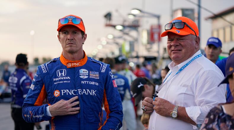 FILE - Scott Dixon, left, stands next to Chip Ganassi before the start an IndyCar auto race at World Wide Technology Raceway on Aug. 21, 2021, in Madison, Ill. (AP Photo/Jeff Roberson, File)