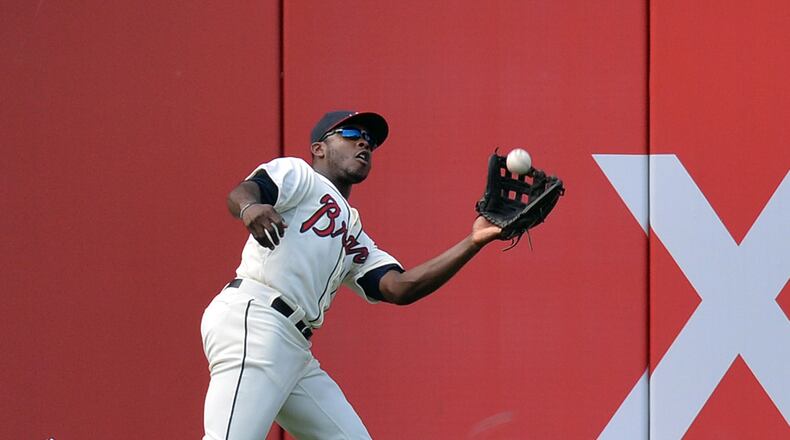 Braves left fielder Justin Upton (8) catches a fly ball hit by San Francisco Giants third baseman Joaquin Arias (13) in the 3rd inning at Turner Field in Atlanta on Saturday, June 15, 2013.