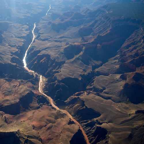 Bright Angel Canyon, middle left, the scene of flash floods, meets with the Colorado River in the Grand Canyon, Monday, Aug. 31, 2026, at Grand Canyon National Park, Ariz. (AP Photo/John Locher)