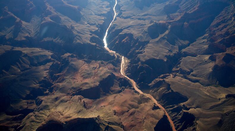 Bright Angel Canyon, middle left, the scene of flash floods, meets with the Colorado River in the Grand Canyon, Monday, Aug. 31, 2026, at Grand Canyon National Park, Ariz. (AP Photo/John Locher)