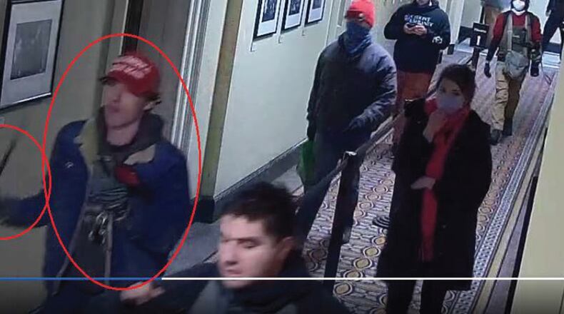 In the FBI's criminal complaint against 18-year-old Bruno Cua of Milton, Cua is identified in a U.S. Capitol surveillance video swinging what appears to be a baton.