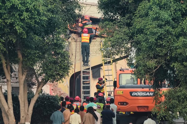 Rescue workers recover a body from a damaged building at the site of a suspected Indian missile attack, in Muridke, a town in Pakistan's Punjab province, Wednesday, May 7, 2025. (AP Photo/K.M. Chaudary)